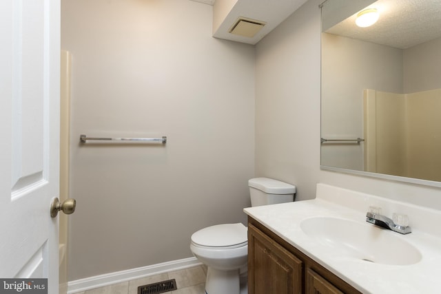 bathroom with tile patterned flooring, vanity, and toilet