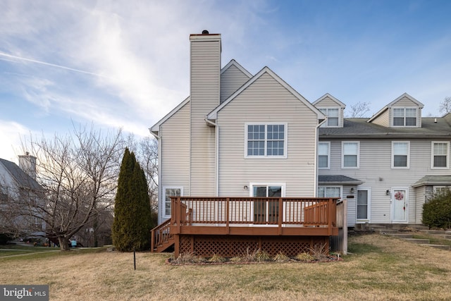 rear view of house with a lawn and a deck