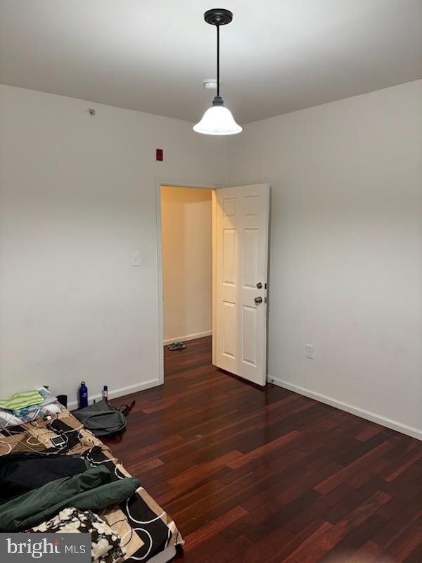 empty room featuring dark hardwood / wood-style flooring