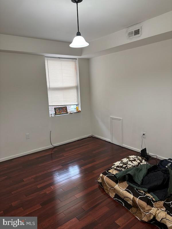 spare room with dark wood-type flooring