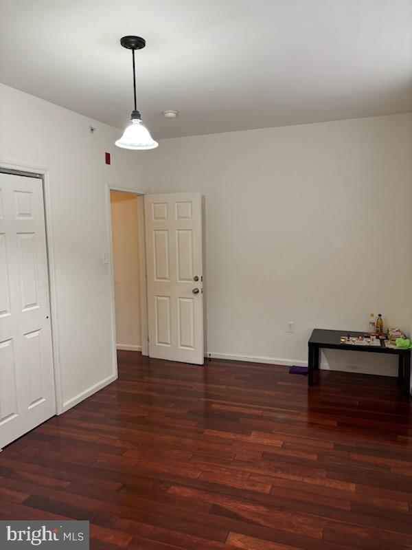 empty room featuring dark wood-type flooring