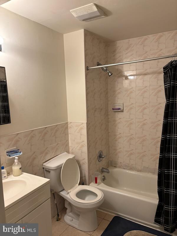 full bathroom with vanity, tile patterned flooring, shower / bath combo, and tile walls