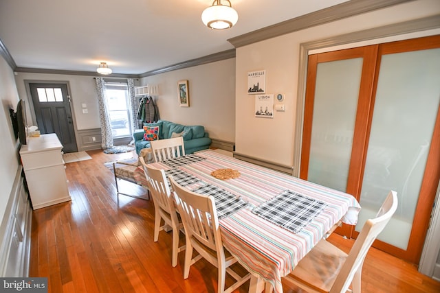 dining room featuring hardwood / wood-style floors and ornamental molding