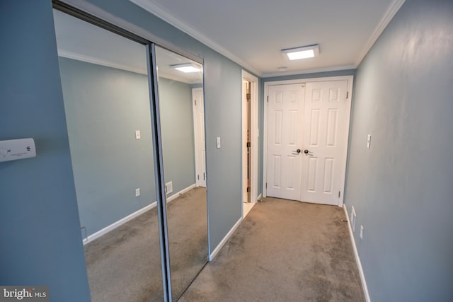 hallway with crown molding and light colored carpet