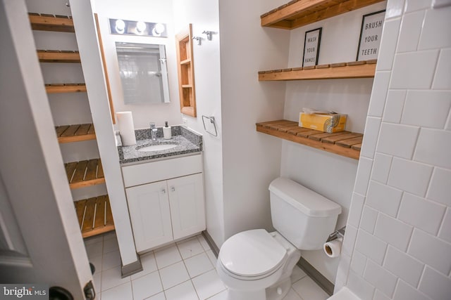 bathroom featuring tile patterned floors, vanity, and toilet