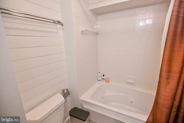 bathroom featuring shower / bathtub combination with curtain and toilet