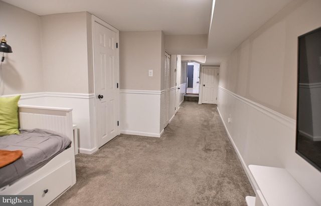 hall featuring light colored carpet