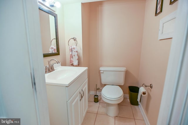 bathroom featuring tile patterned flooring, vanity, and toilet