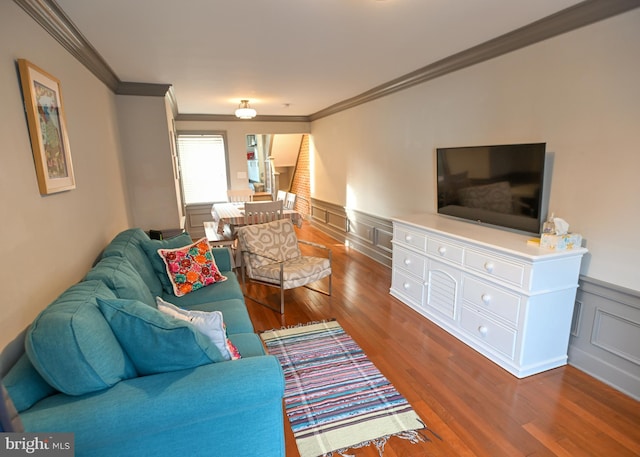 living room featuring crown molding and hardwood / wood-style floors