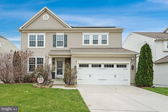 view of front of property with a front yard and a garage