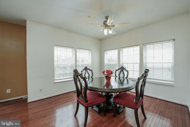 dining space featuring dark hardwood / wood-style flooring, ceiling fan, and crown molding