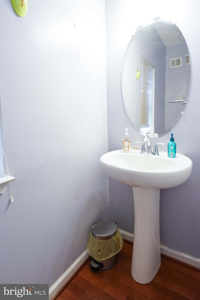 bathroom with hardwood / wood-style flooring and sink