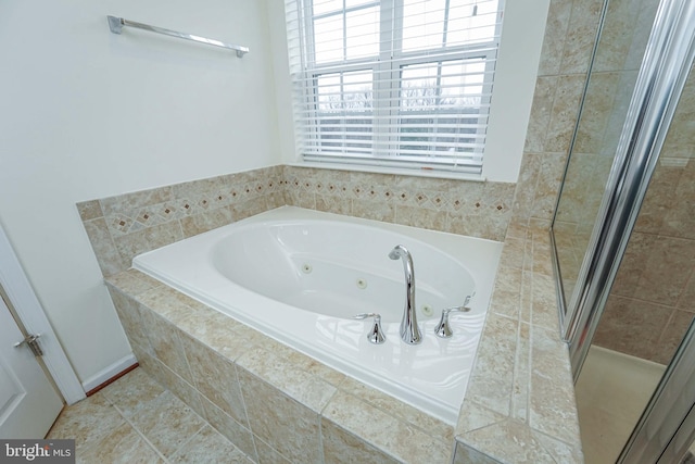 bathroom featuring tile patterned floors and separate shower and tub