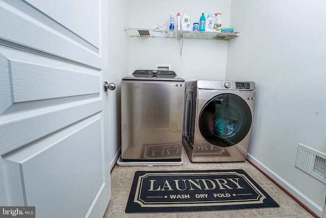 clothes washing area with separate washer and dryer