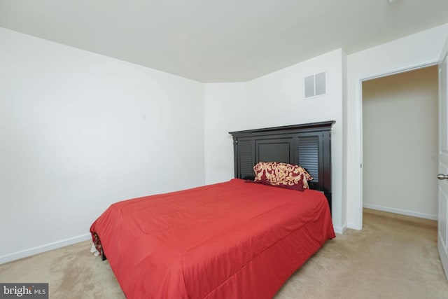 bedroom featuring light carpet