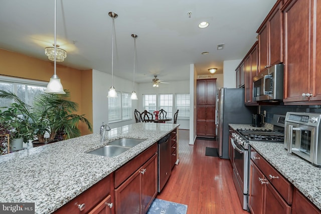 kitchen with pendant lighting, stainless steel appliances, plenty of natural light, and sink