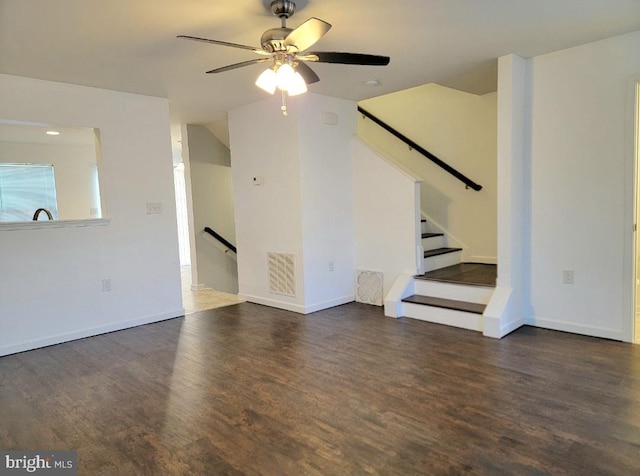 unfurnished living room featuring dark hardwood / wood-style flooring and ceiling fan