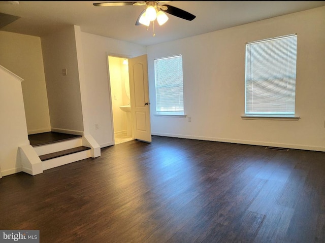 empty room featuring ceiling fan and dark hardwood / wood-style floors