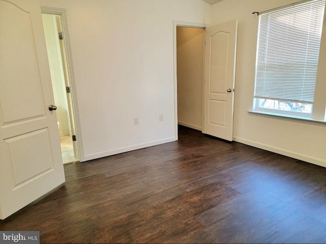 unfurnished room featuring dark hardwood / wood-style flooring