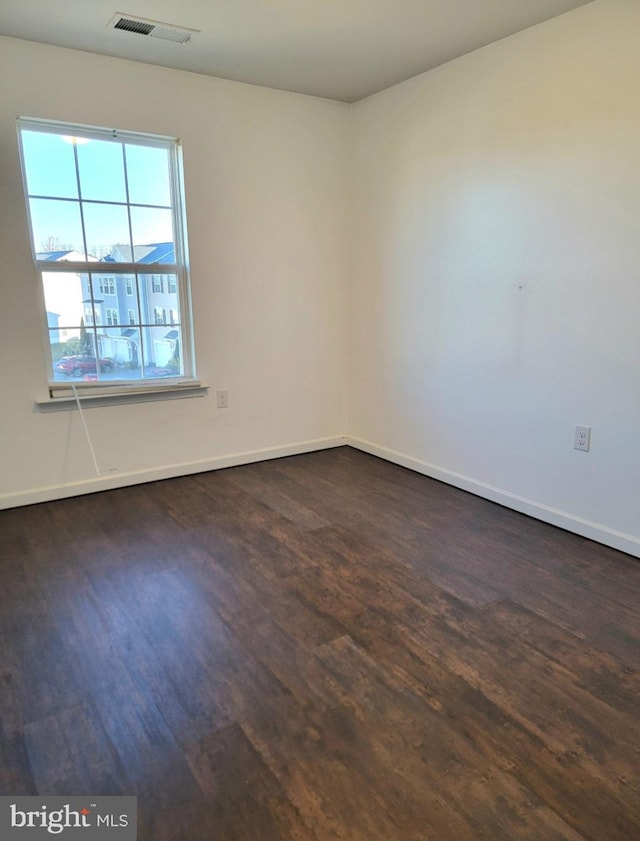 spare room with dark hardwood / wood-style floors