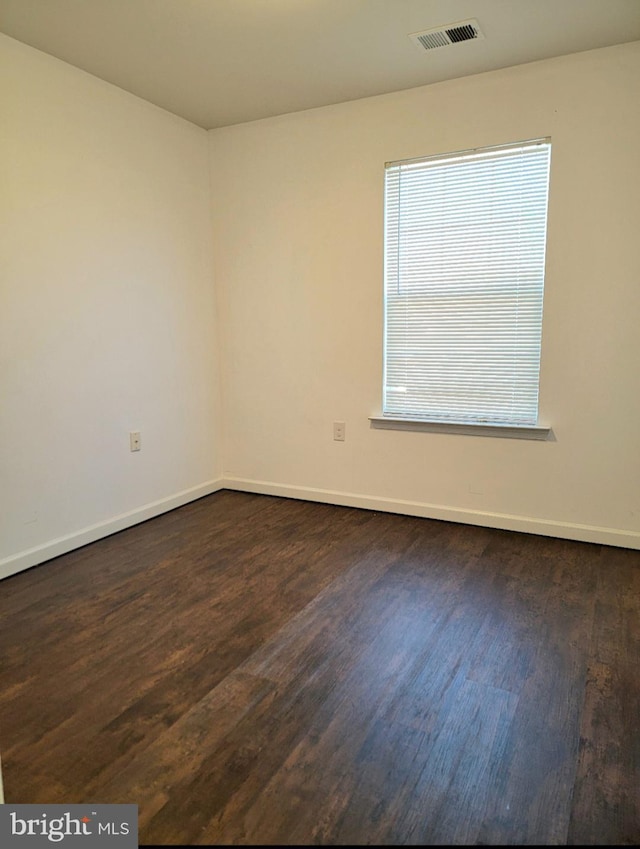 empty room featuring dark hardwood / wood-style flooring