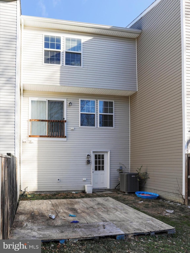 back of property with central air condition unit and a patio