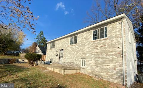 rear view of house with a yard