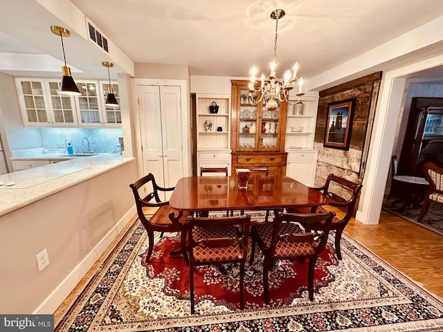 dining area with an inviting chandelier and sink