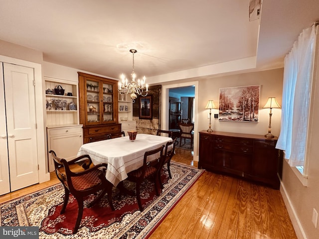 dining space with a chandelier and light hardwood / wood-style floors