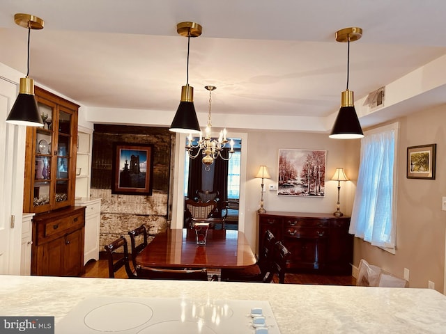 dining space featuring dark hardwood / wood-style flooring and a chandelier