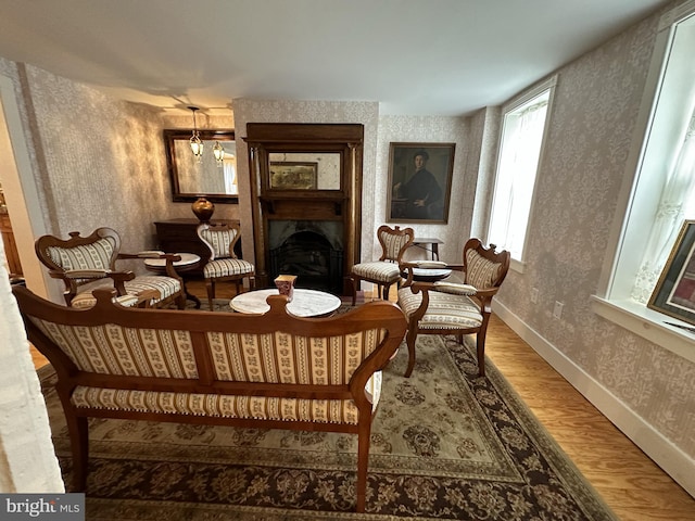 living area with hardwood / wood-style flooring and an inviting chandelier