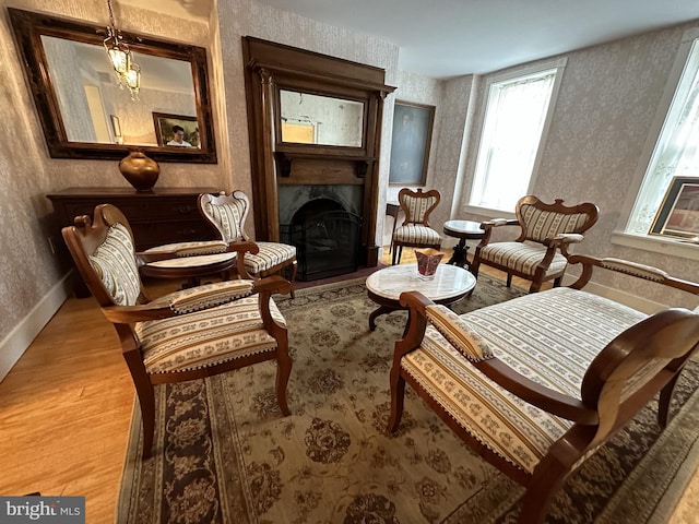 sitting room with an inviting chandelier and light hardwood / wood-style flooring