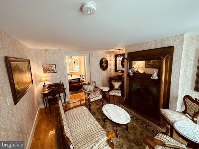 sitting room with dark hardwood / wood-style floors and a notable chandelier