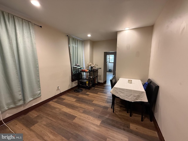 dining space with dark hardwood / wood-style flooring