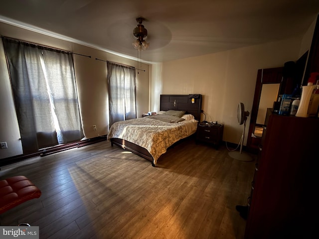 bedroom featuring dark hardwood / wood-style flooring and ceiling fan