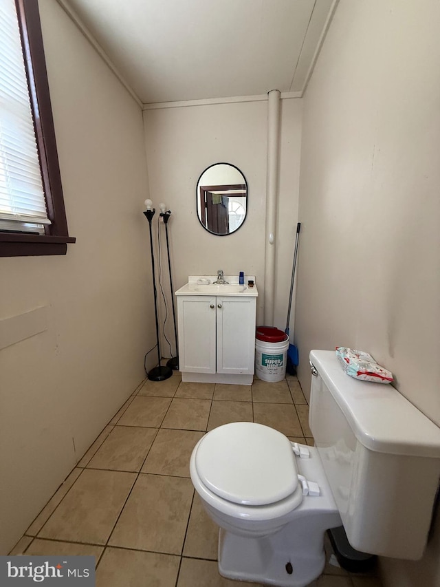 bathroom featuring toilet, vanity, and tile patterned floors