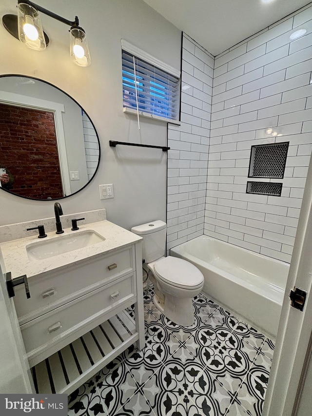 full bathroom featuring toilet, vanity, tiled shower / bath combo, and tile patterned floors