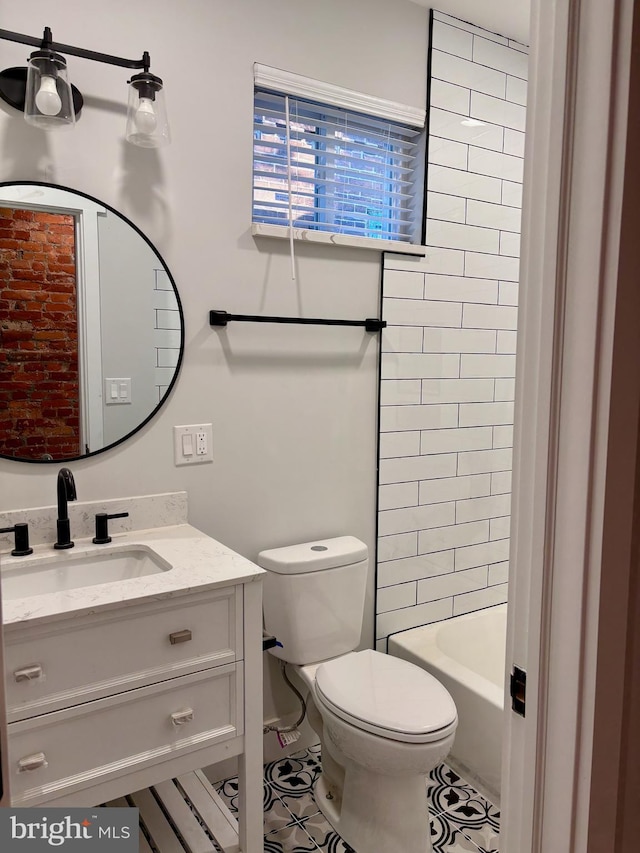 full bathroom with tile patterned flooring, vanity, toilet, and tiled shower / bath