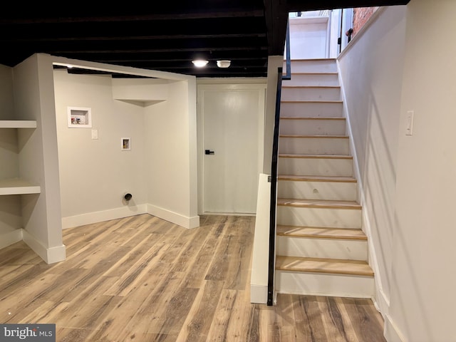 interior space featuring washer hookup and wood-type flooring