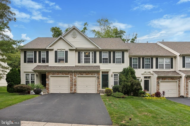 view of front of property featuring a garage and a front lawn