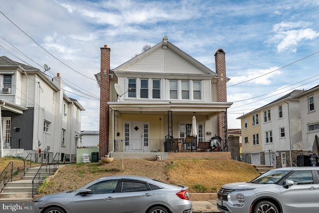 front of property with a porch and cooling unit