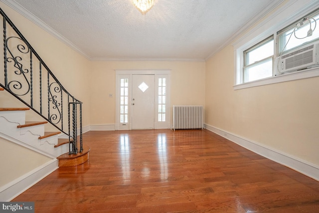 17 Elm Ave, Upper Darby, PA 19082 - foyer featuring radiator heating unit, a textured ceiling, wood finished floors, ornamental molding, and stairway