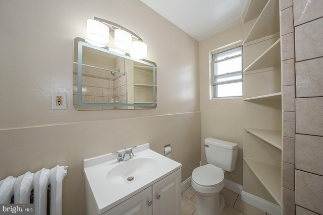 bathroom featuring tile patterned flooring, vanity, toilet, and radiator