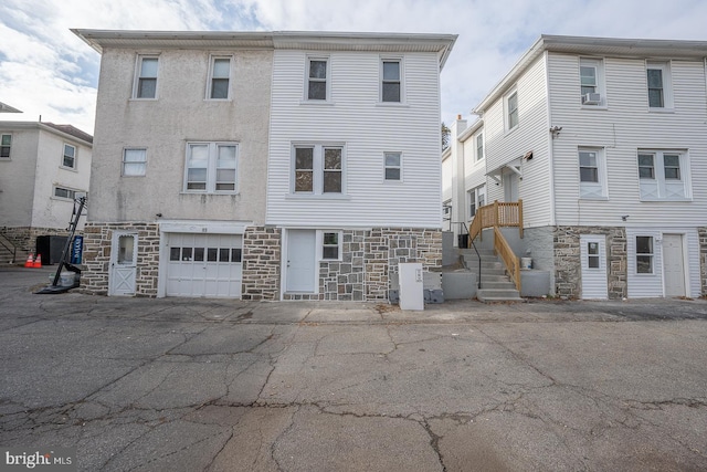 rear view of property with a garage