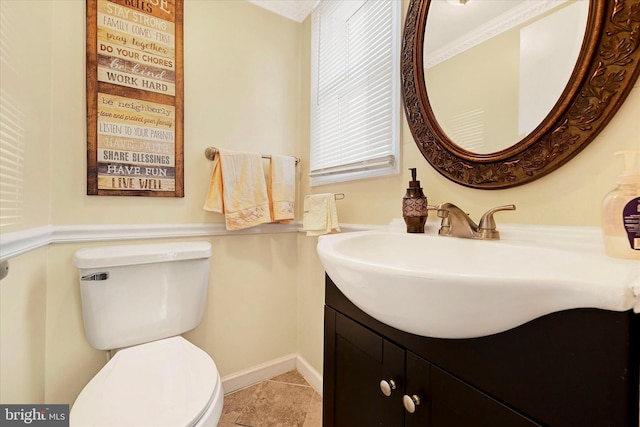 bathroom with tile patterned floors, vanity, toilet, and crown molding