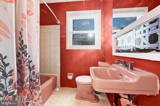 full bathroom with tile patterned floors, shower / bath combo, toilet, and sink