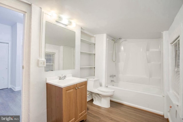 full bathroom with vanity, toilet, wood-type flooring, and bathtub / shower combination