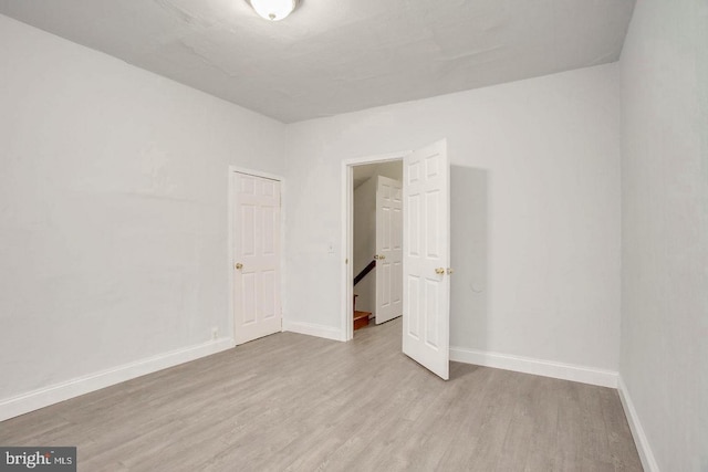 spare room with light wood-type flooring