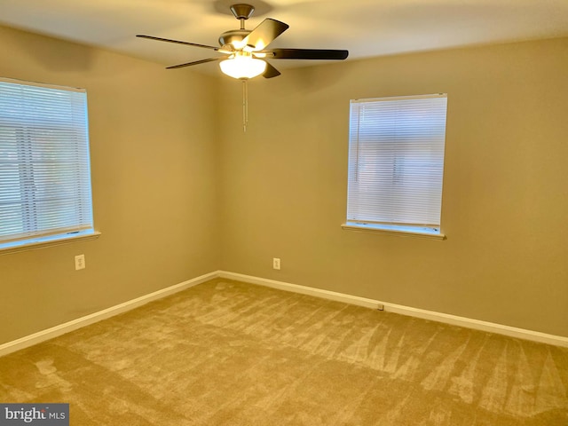 carpeted empty room with ceiling fan