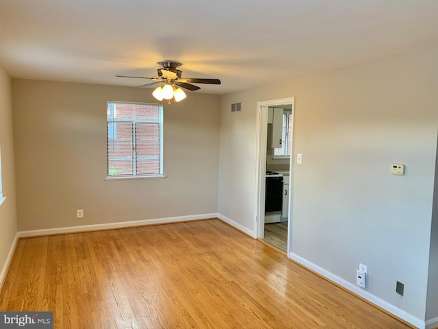 spare room featuring ceiling fan and light hardwood / wood-style flooring